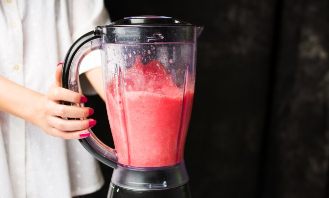 nutribullet pro 900 blender woman holding blender red smoothie